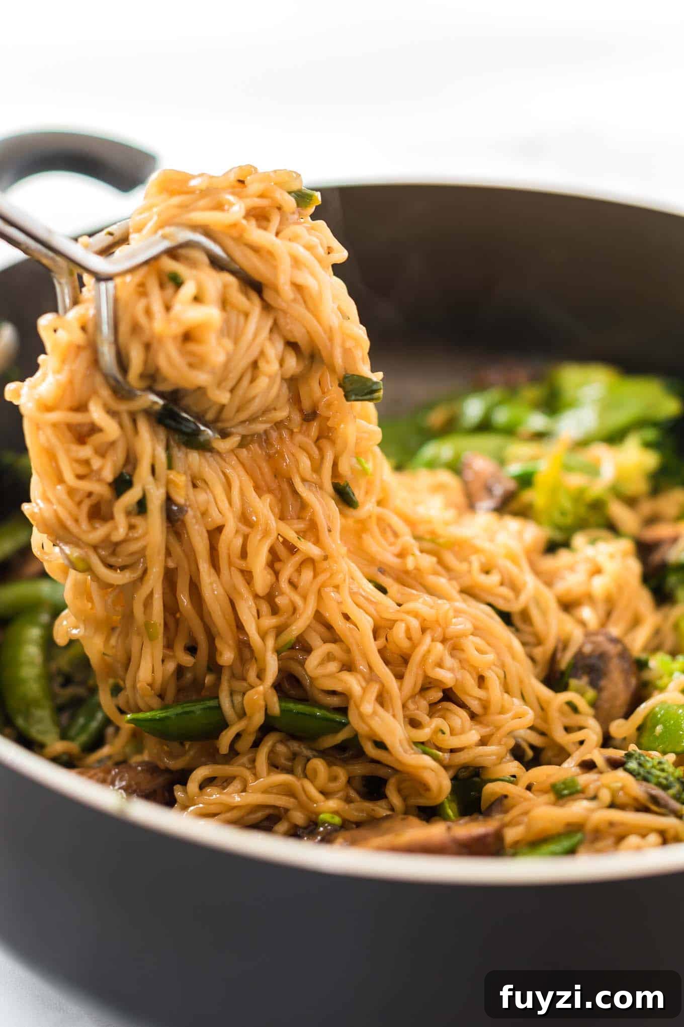 grabbing a serving of teriyaki noodles
