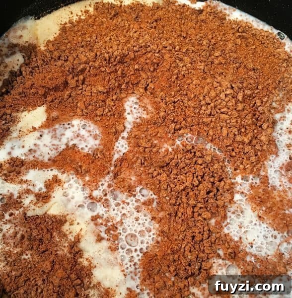 chocolate bits in milk melting in sauce pan