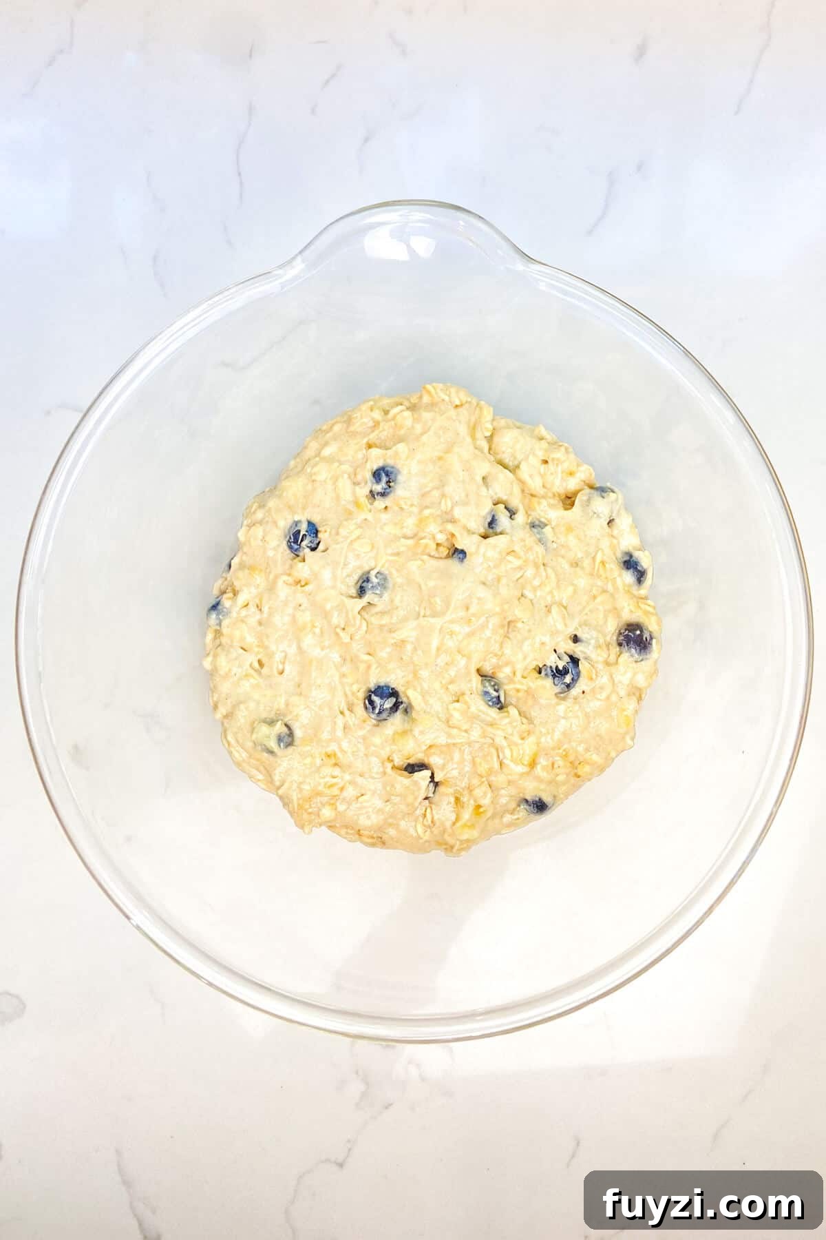 Mixed batter in large glass bowl.