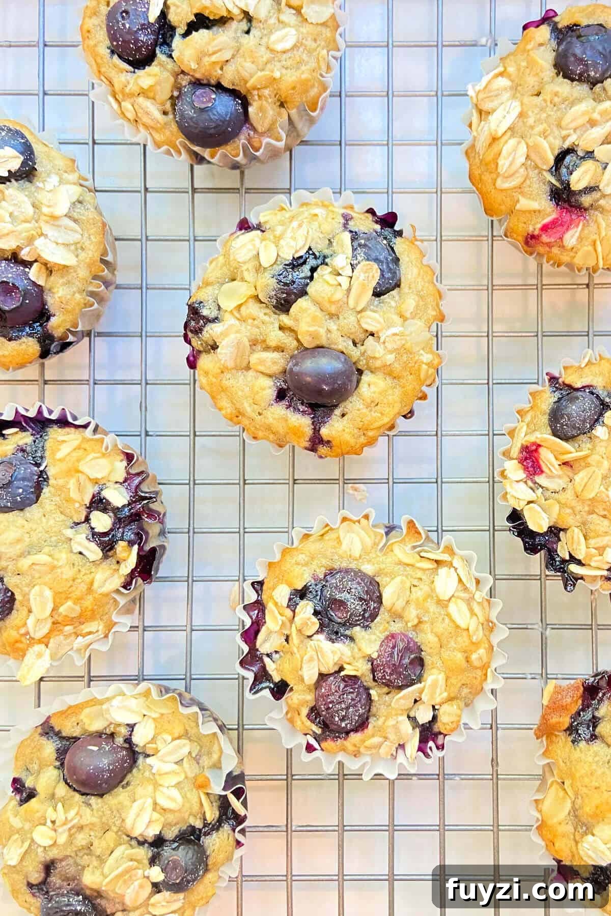 Freshly baked muffins on a cooling rack.