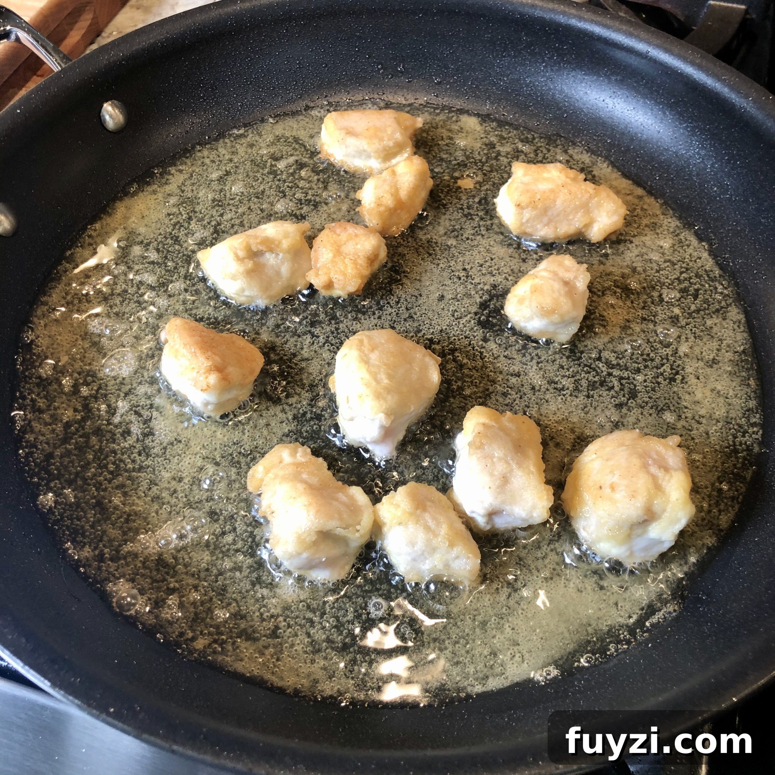 Crispy Restaurant-Style Sesame Chicken Recipe 8 Tossing chicken in sauce