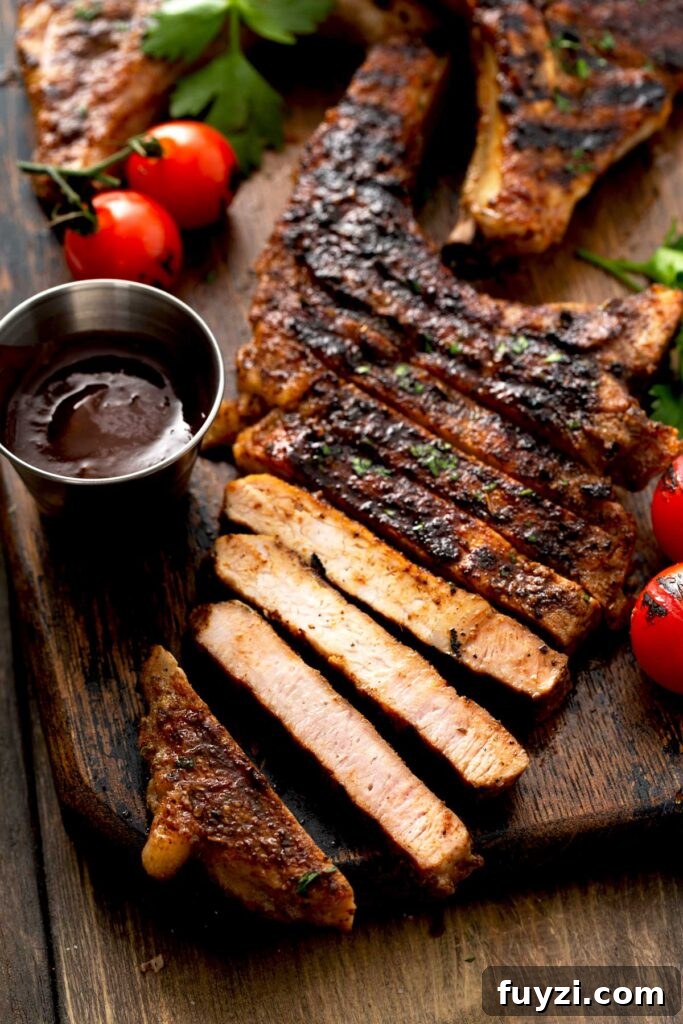 Sliced seasoned grilled pork chops on a wooden board