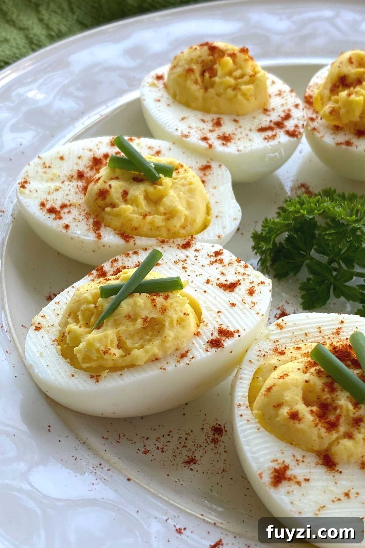 Keto deviled eggs in a semi-circle on a plate.