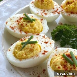 Keto deviled eggs in a semi-circle on a plate.