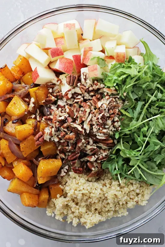 Make-ahead fall quinoa salad, perfect for dinner or Thanksgiving. All the components for Butternut Squash Quinoa Salad in a mixing bowl.