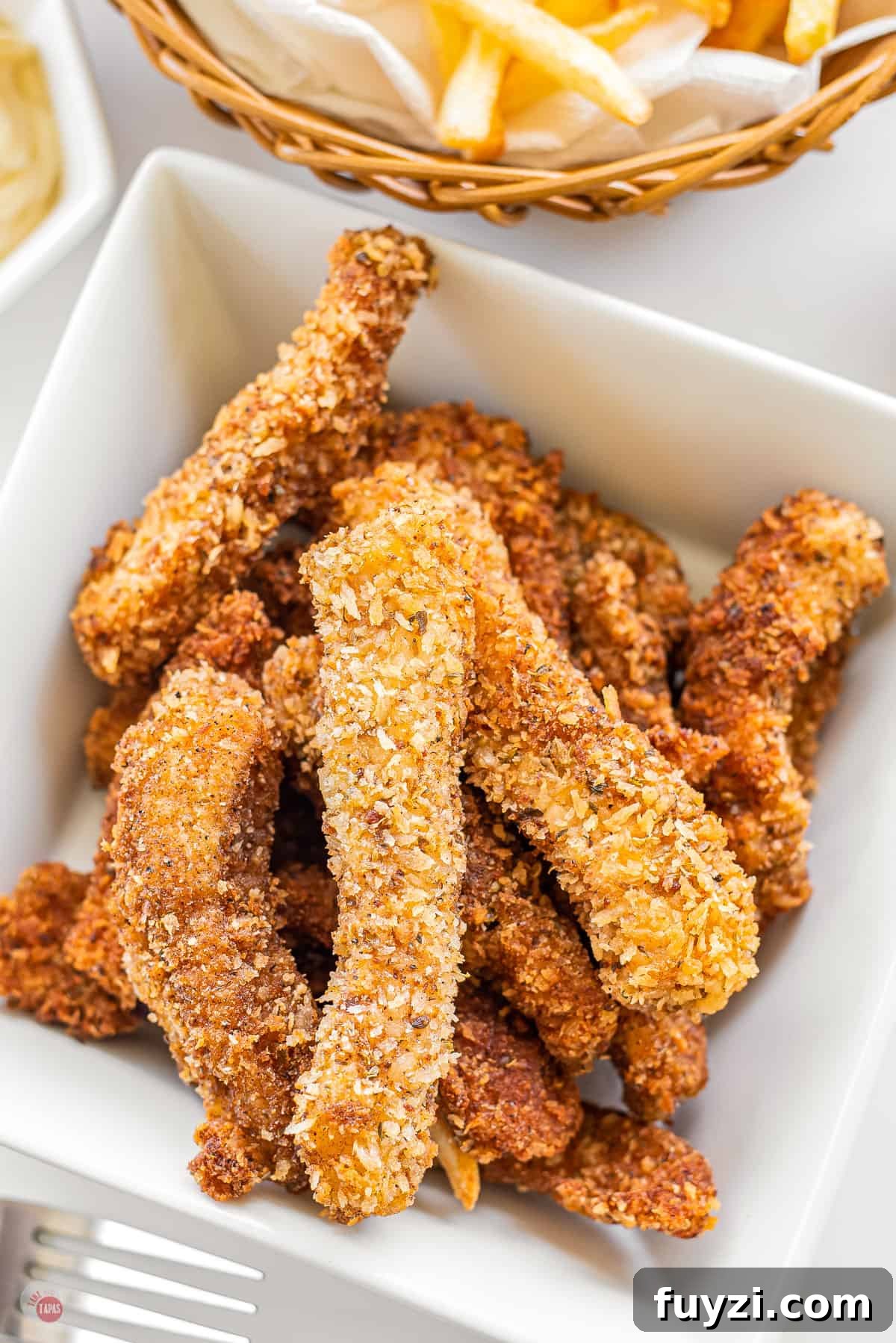 white square bowl with air fryer fish sticks