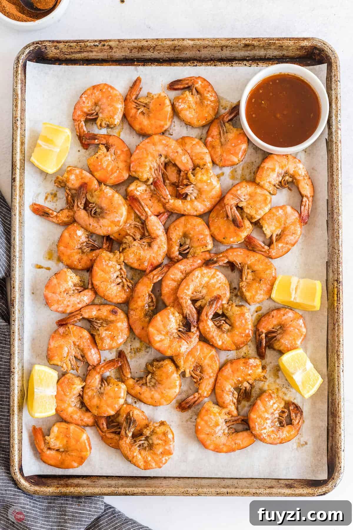 shrimp and lemons on a baking sheet