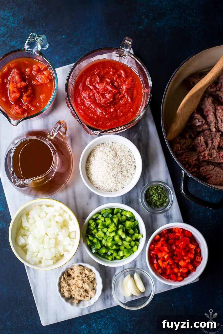 Overhead photo of ingredients for stuffed pepper soup in bowls on marble board
