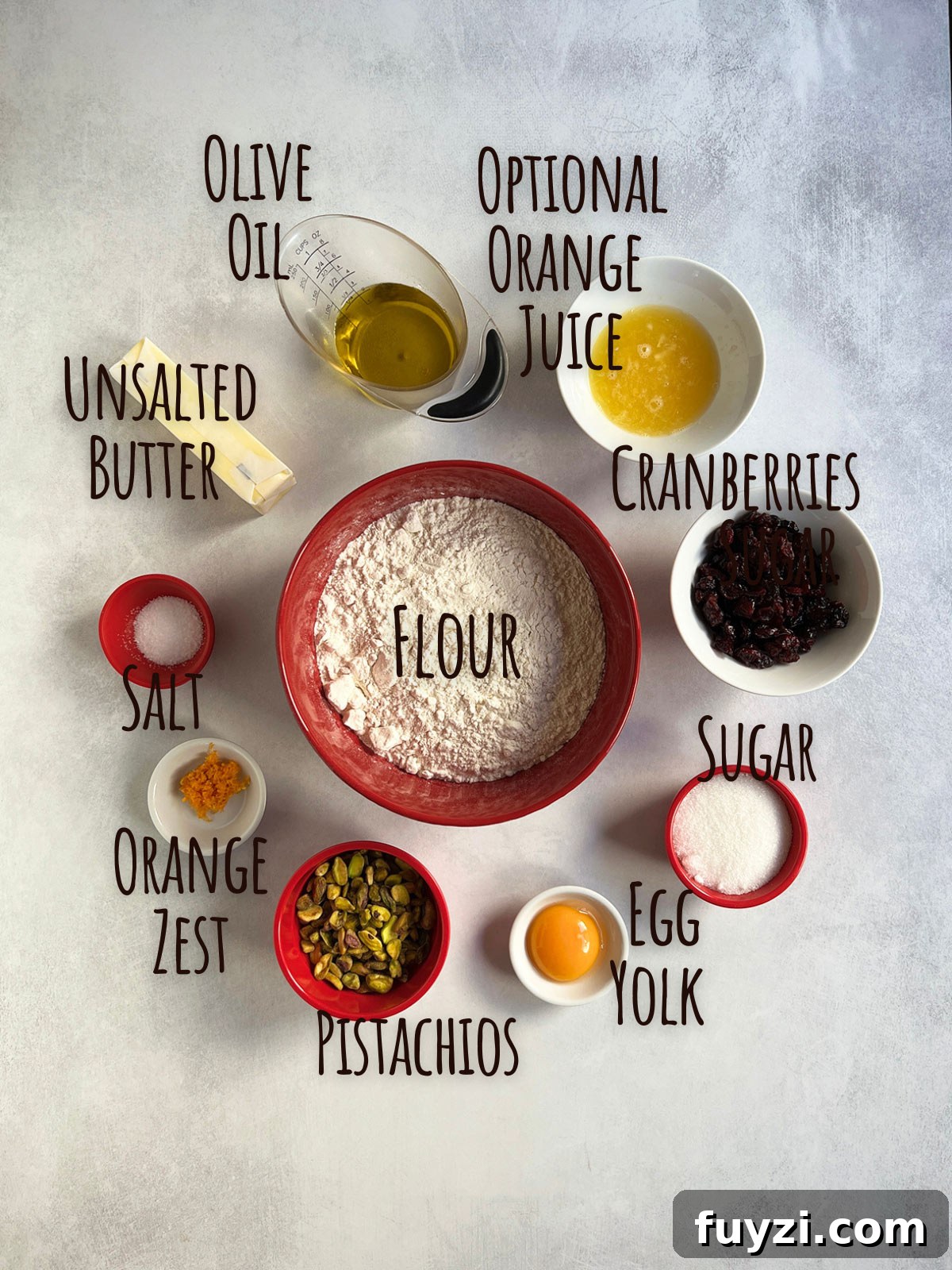 Ingredient shot for cranberry shortbread cookies showing flour in the center with other ingredients around the bowl.