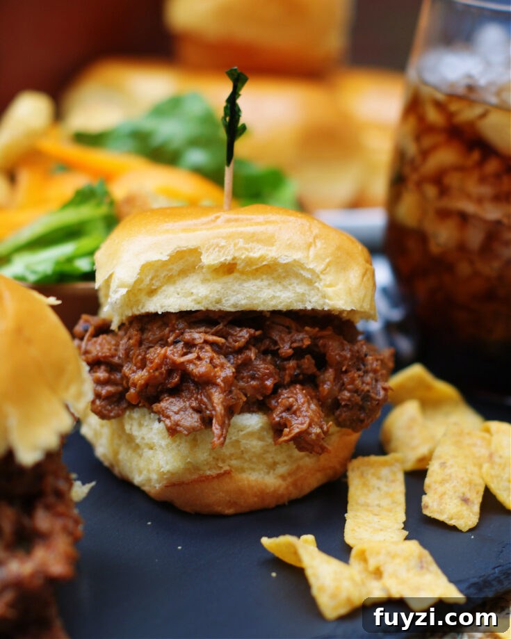 shredded chuck roast cooked in homemade tangy and sweet bbq sauce in the crock pot for sandwiches or as a main dish
