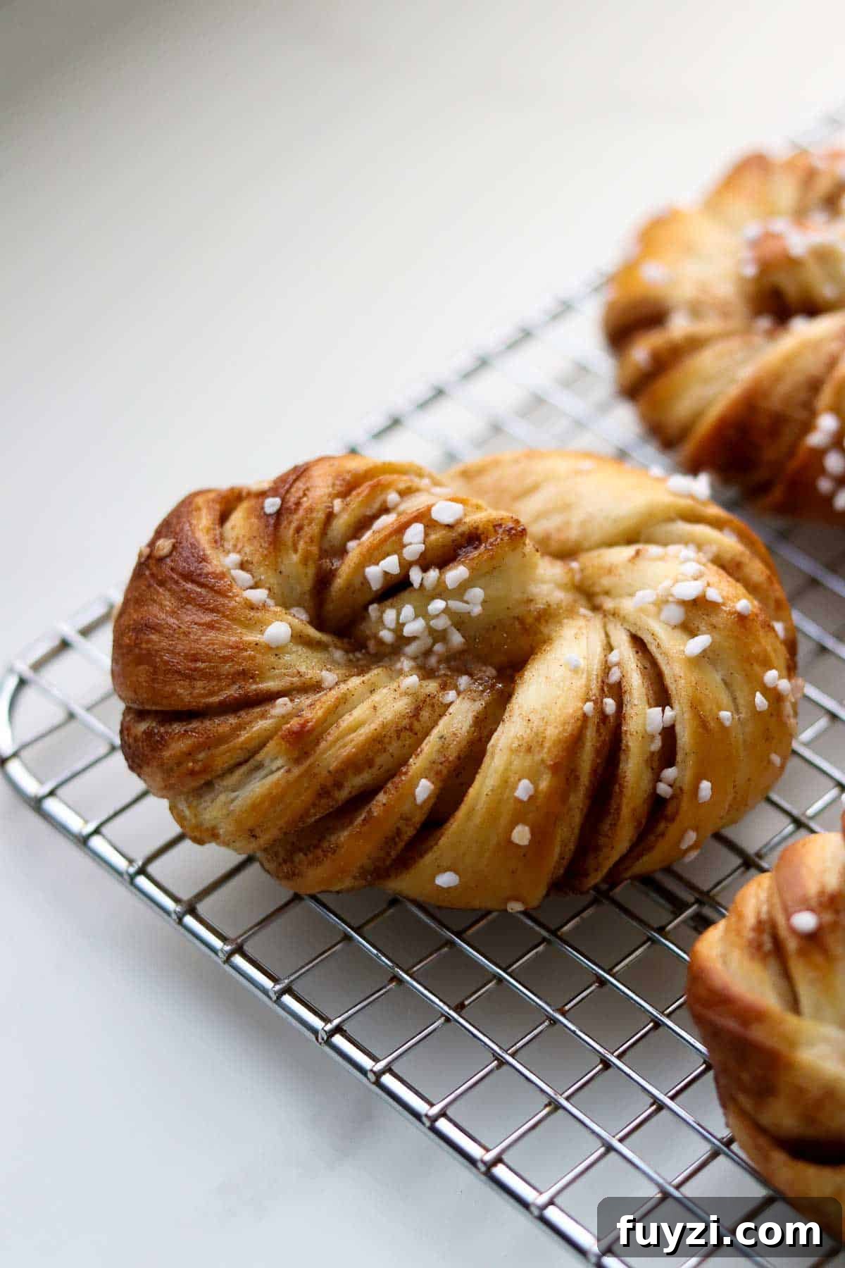 Swedish Cinnamon Buns (Kanelbullar) cooling on a wire rack.