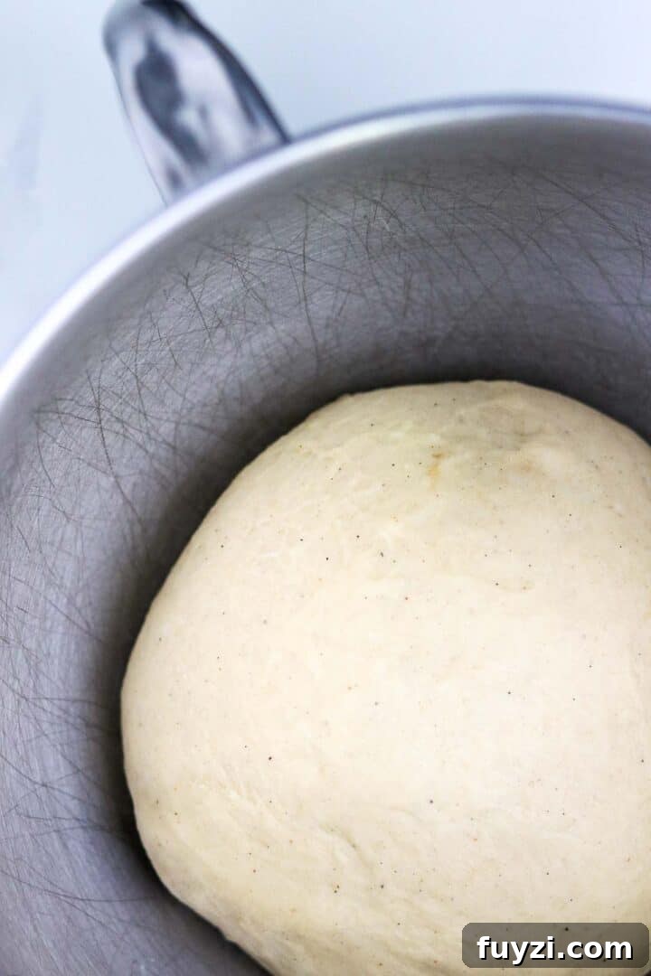 Swedish Cinnamon Bun (Kanelbullar) dough in a metal bowl.