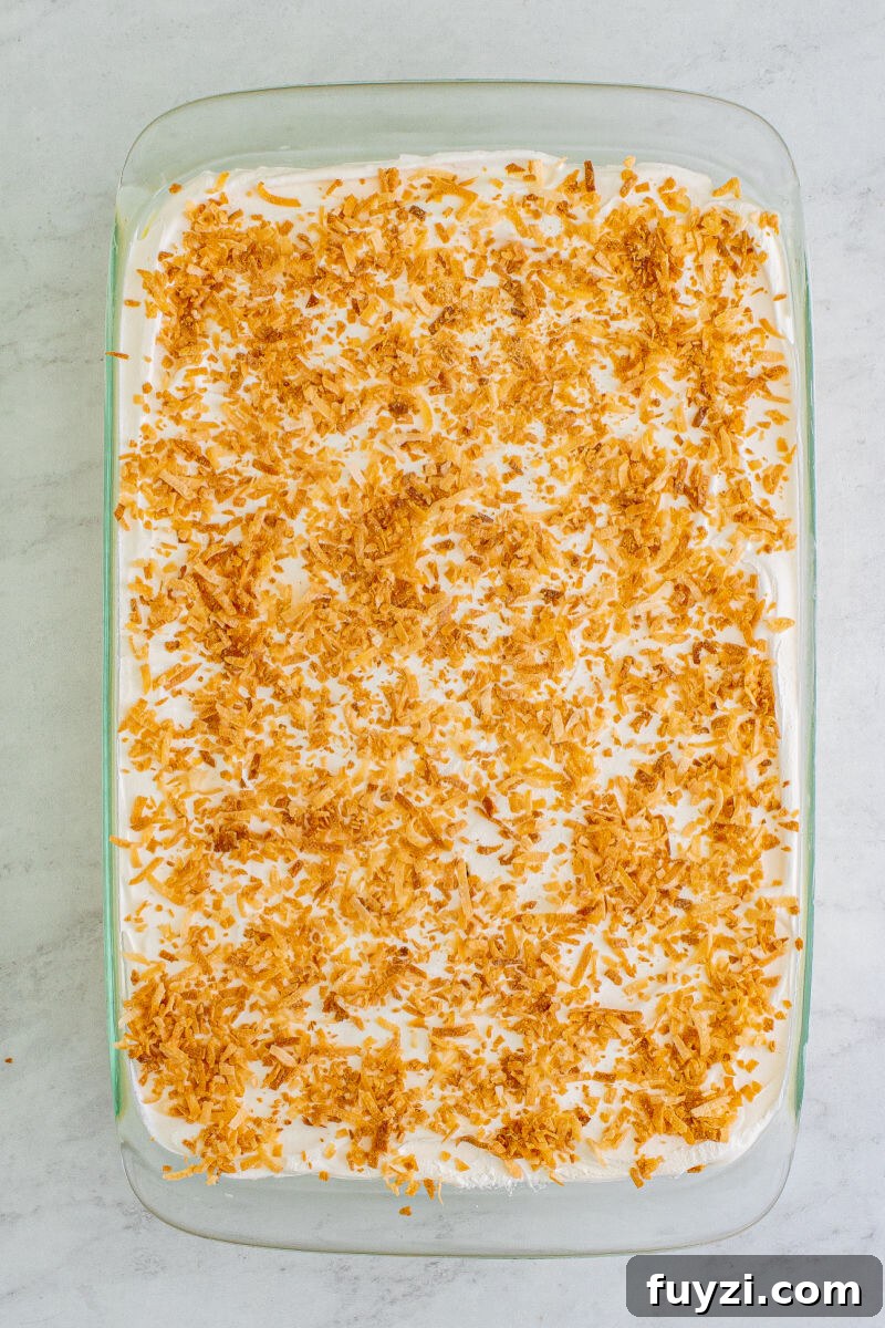 looking down at a coconut icebox cake topped with toasted coconut