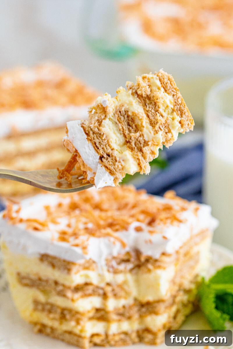 bite of coconut icebox cake on a fork over the plate