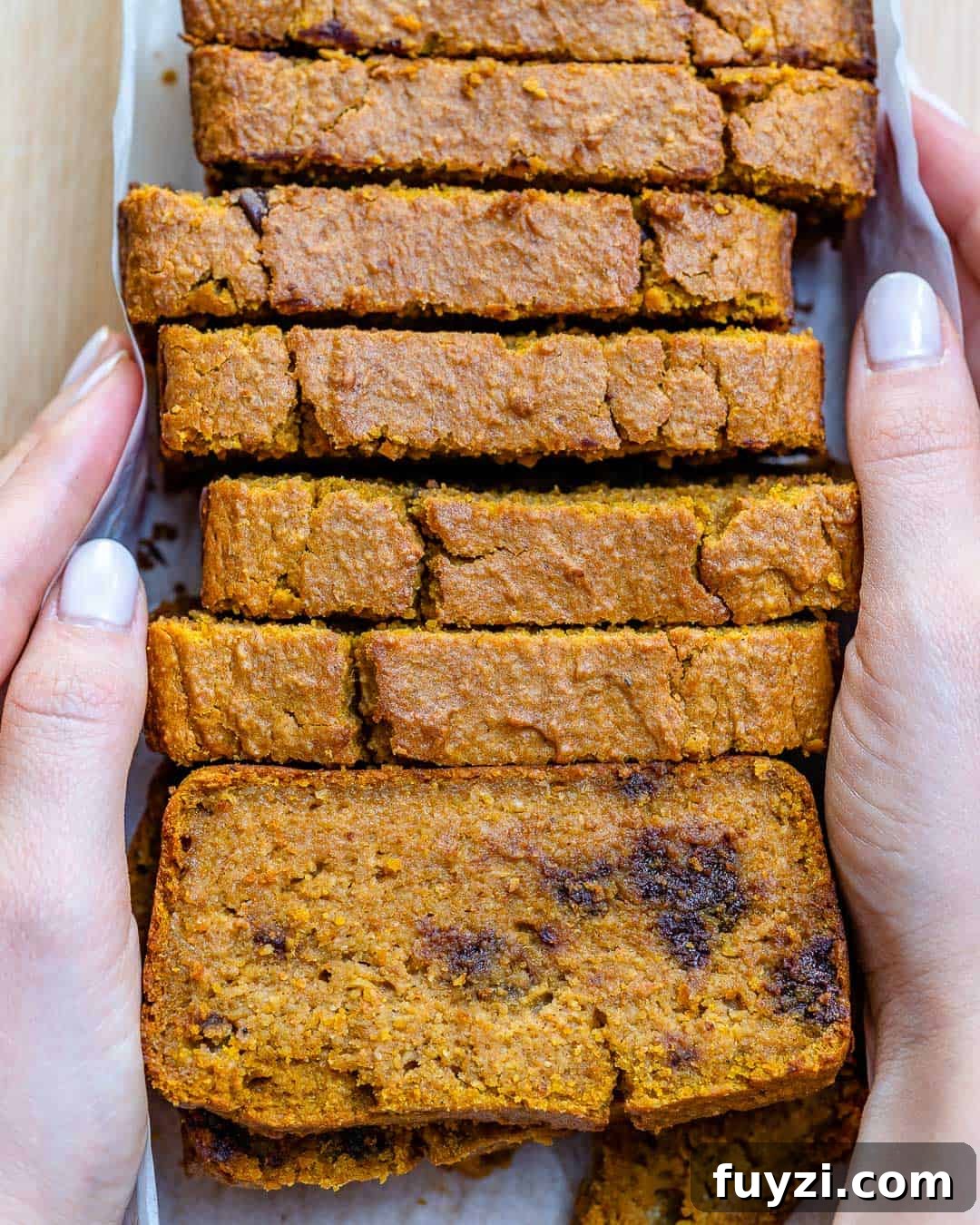 pumpkin bread recipe hand holding slices of pumpkin bread