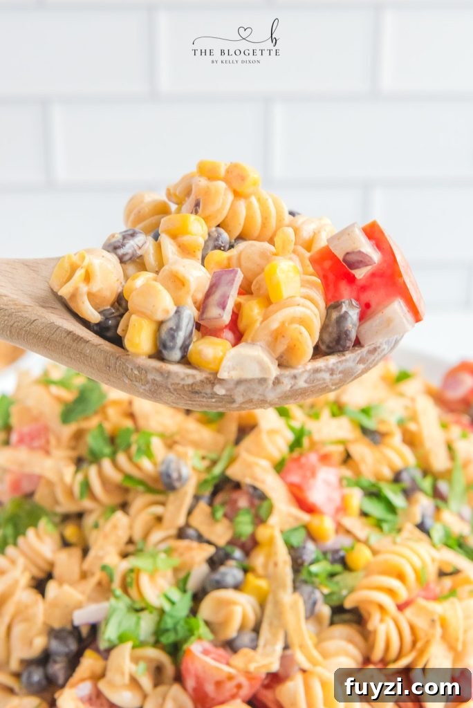 Creamy Ranch Taco Pasta Salad - Ranch dressing and taco seasoning folded into pasta with tomatoes, beans, corn, and more!