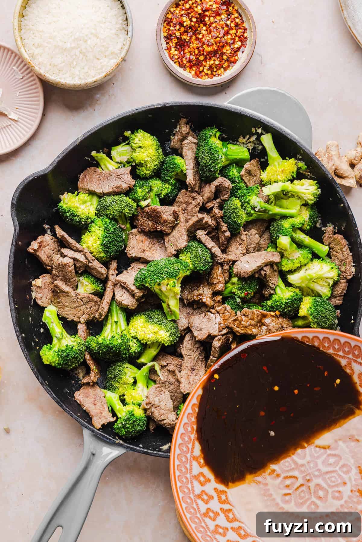 Broccoli and steak cooking in a skillet