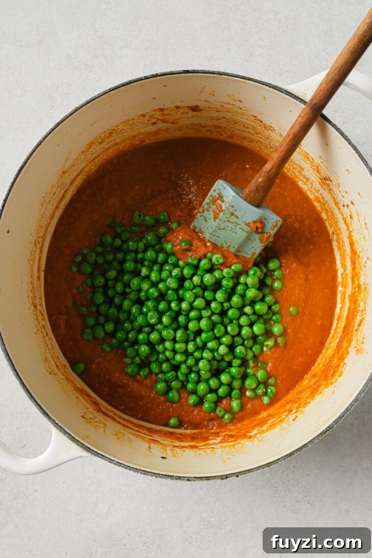 Authentic Restaurant-Style Matar Paneer Recipe 13 Adding peas to onion and tomato mixture.