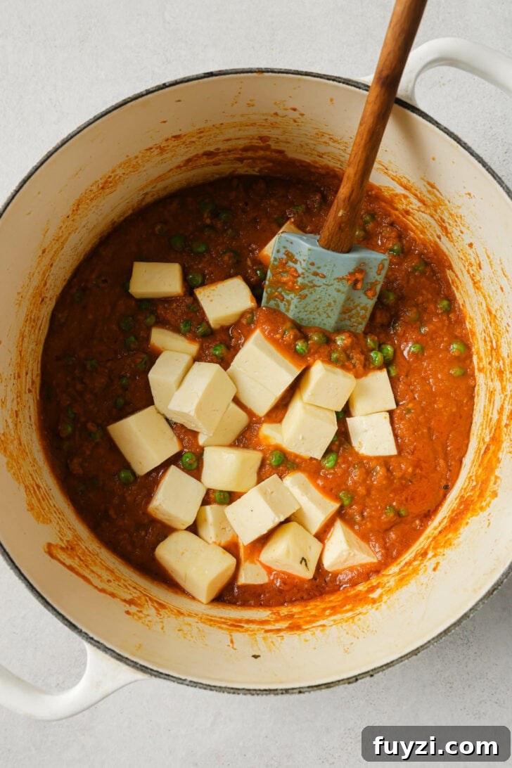 Authentic Restaurant-Style Matar Paneer Recipe 14 Adding paneer to onion-tomato-peas mixture.