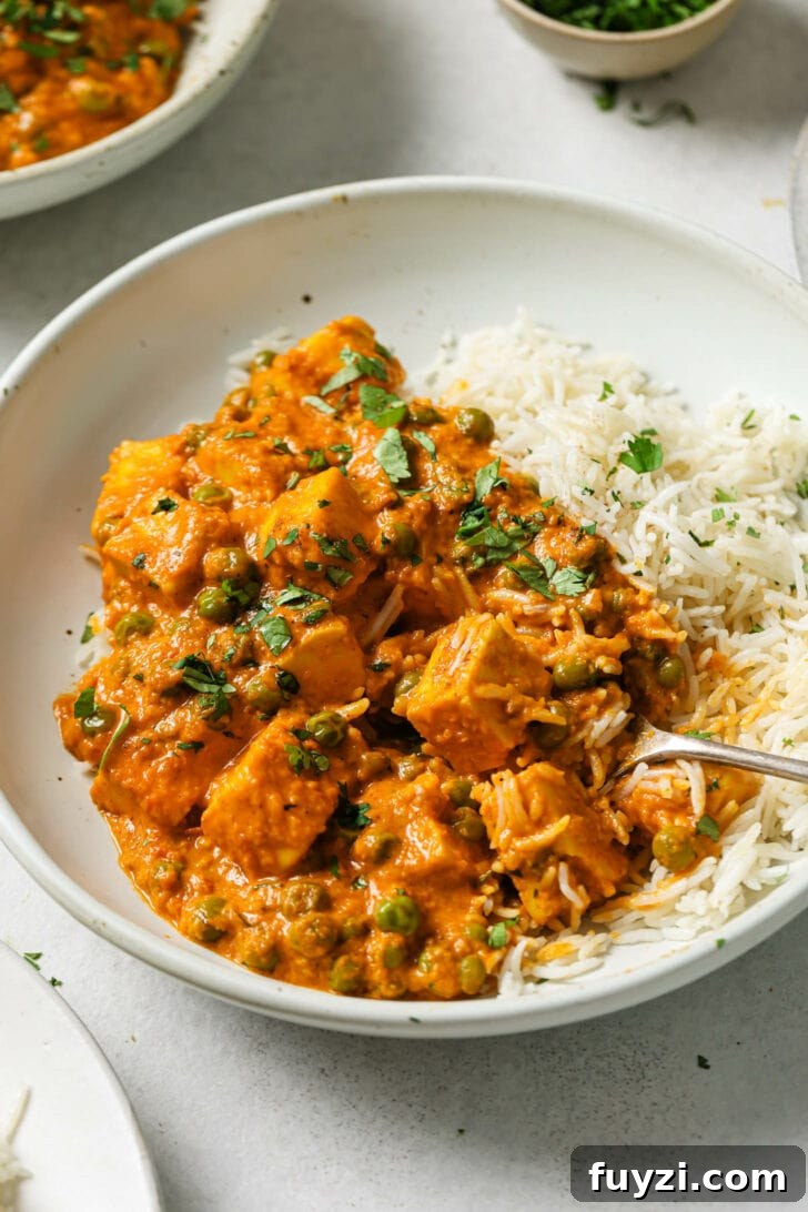 Authentic Restaurant-Style Matar Paneer Recipe 18 Close up of a plate of partially eaten Matar Paneer and rice.