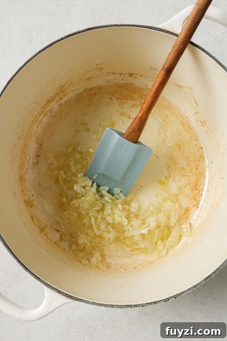 Authentic Restaurant-Style Matar Paneer Recipe 9 Sautéing onions in a dutch oven.
