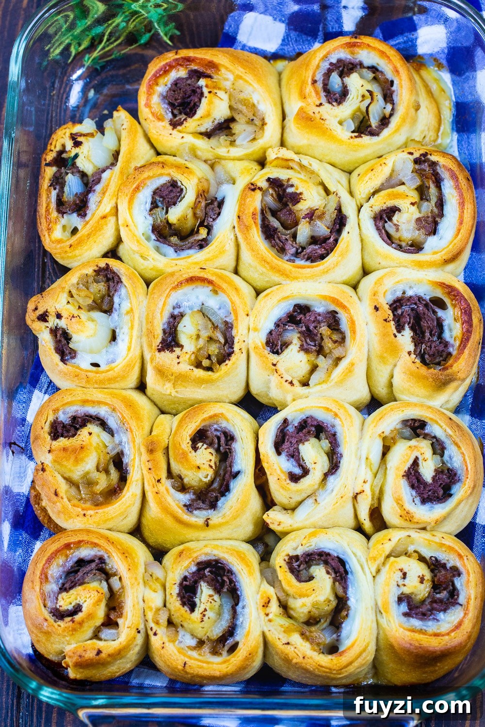 French Dip Pinwheels Recipe: Party Appetizer with Au Jus 3 Pinwheels in a baking dish.