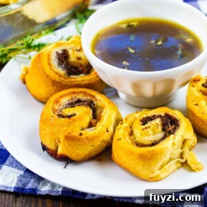 French Dip Pinwheels Recipe: Party Appetizer with Au Jus 5 French Dip Pinwheels on a plate with a bowl of Au Jus.