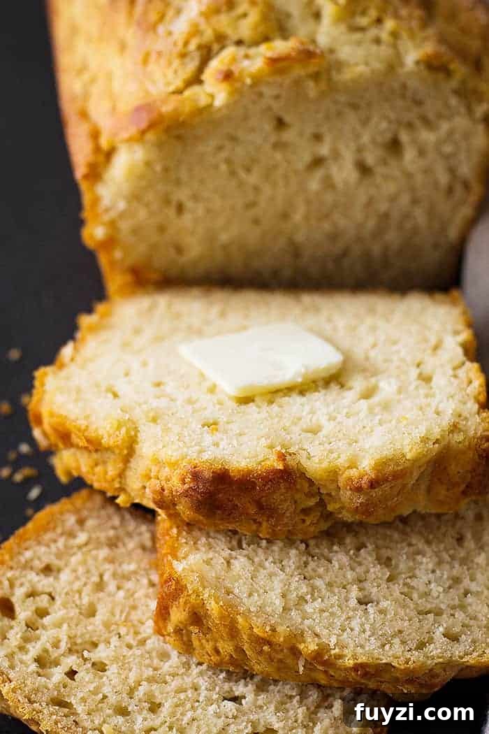 beer bread recipe cut into slices with a pat of butter 