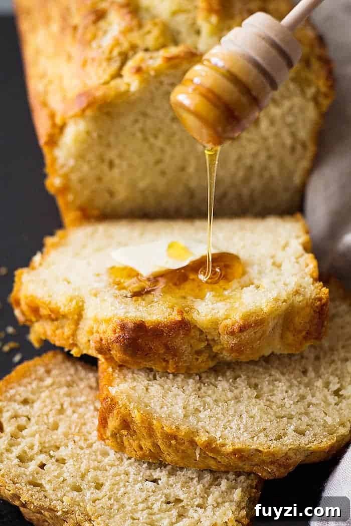 closeup: pouring honey over slices of this easy beer bread recpe
