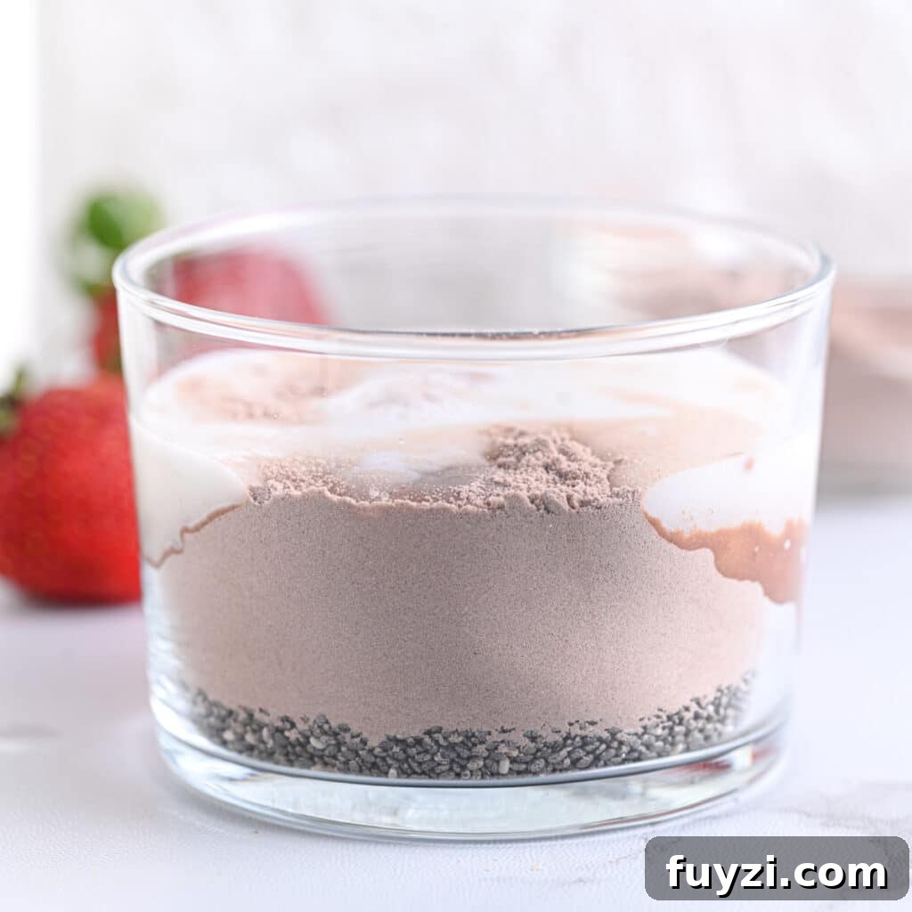 Creamy Chocolate Chia Pudding Recipe 6 Milk added to cocoa powder and chia seeds, ready to mix