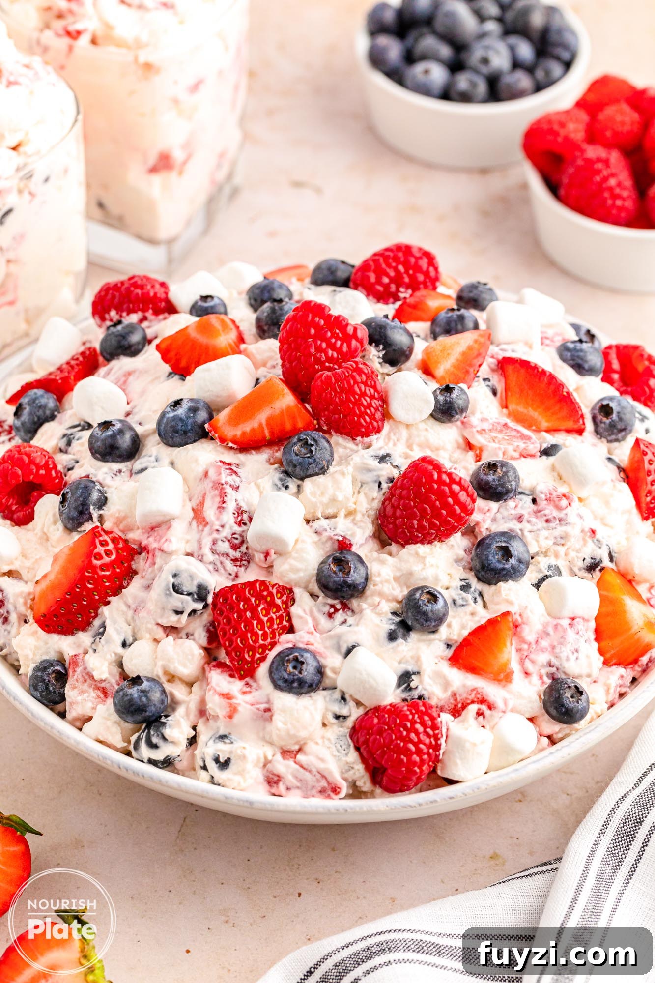 A large white bowl of berry cheesecake salad