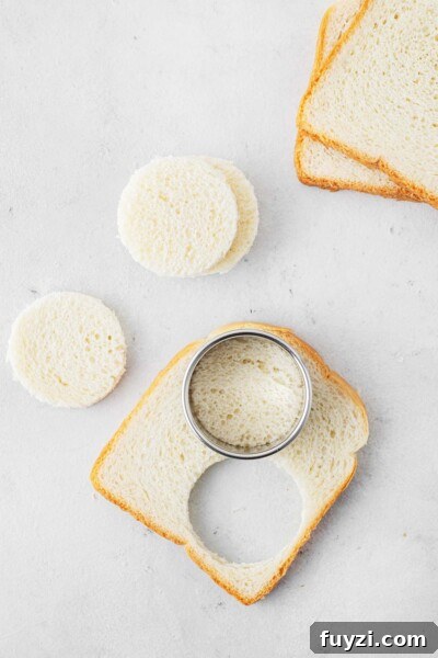 Mini Jam Sandwiches for Afternoon Tea 5 White bread being cut by cookie cutter into small circles.