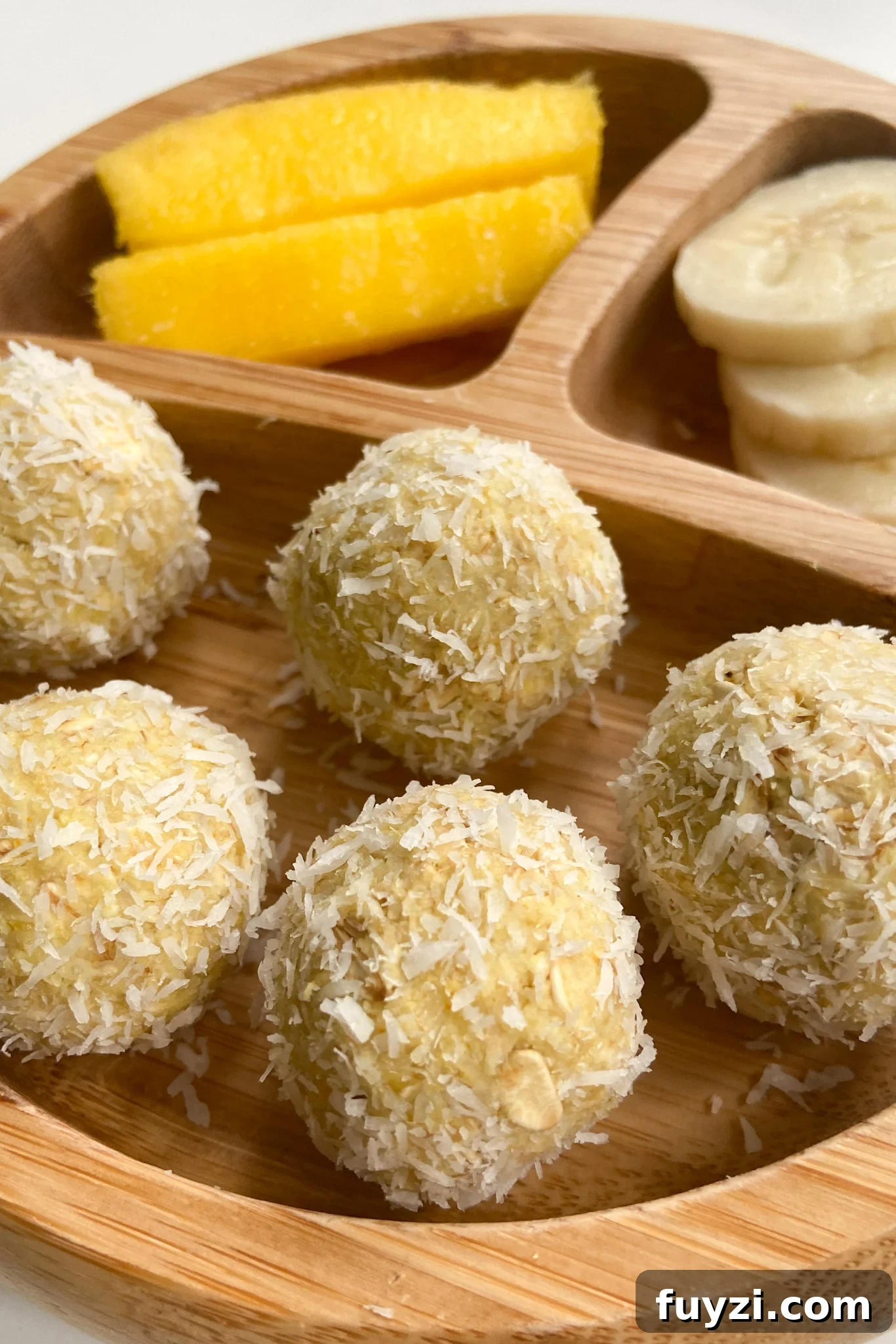 Mango bliss balls served with mangoes and bananas