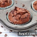 One Chocolate and Zucchini Muffin in the muffin pan