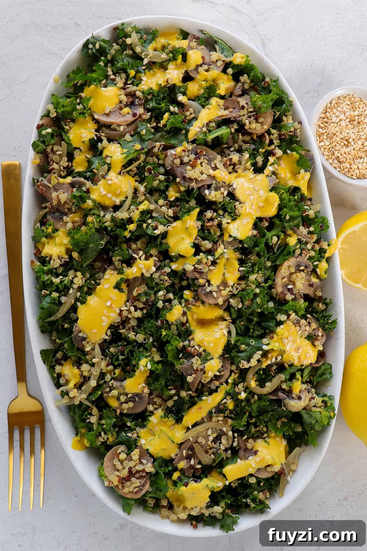 Warm Cheesy Quinoa Salad with Kale and Sauteed Mushrooms 2 Salad served on plate with dressing poured over.