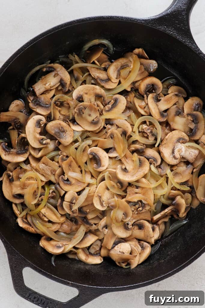 Warm Cheesy Quinoa Salad with Kale and Sauteed Mushrooms 5 Sautéed mushrooms and onions in skillet.