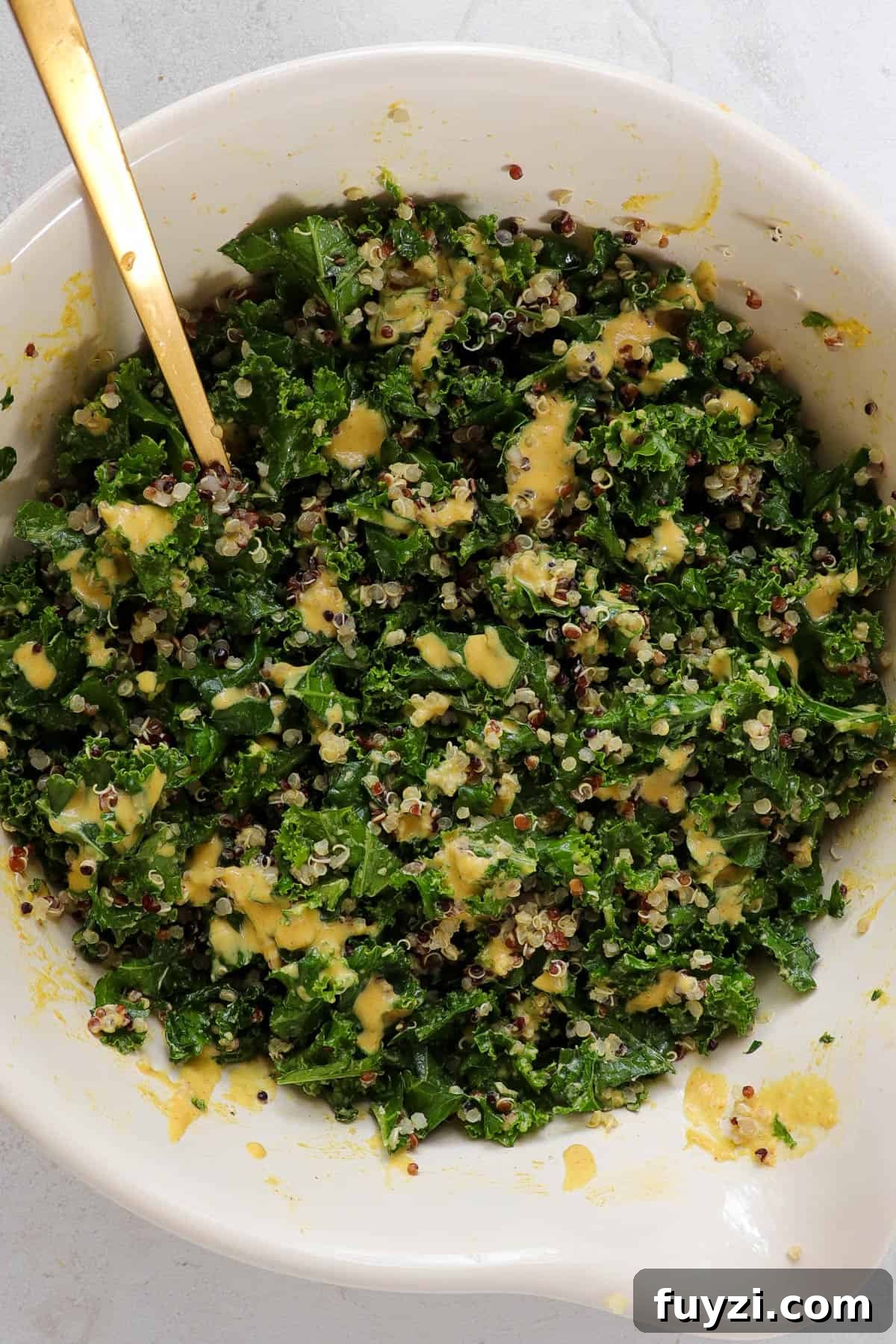 Warm Cheesy Quinoa Salad with Kale and Sauteed Mushrooms 6 Kale and cooked quinoa in a mixing bowl with the cheesy dressing.