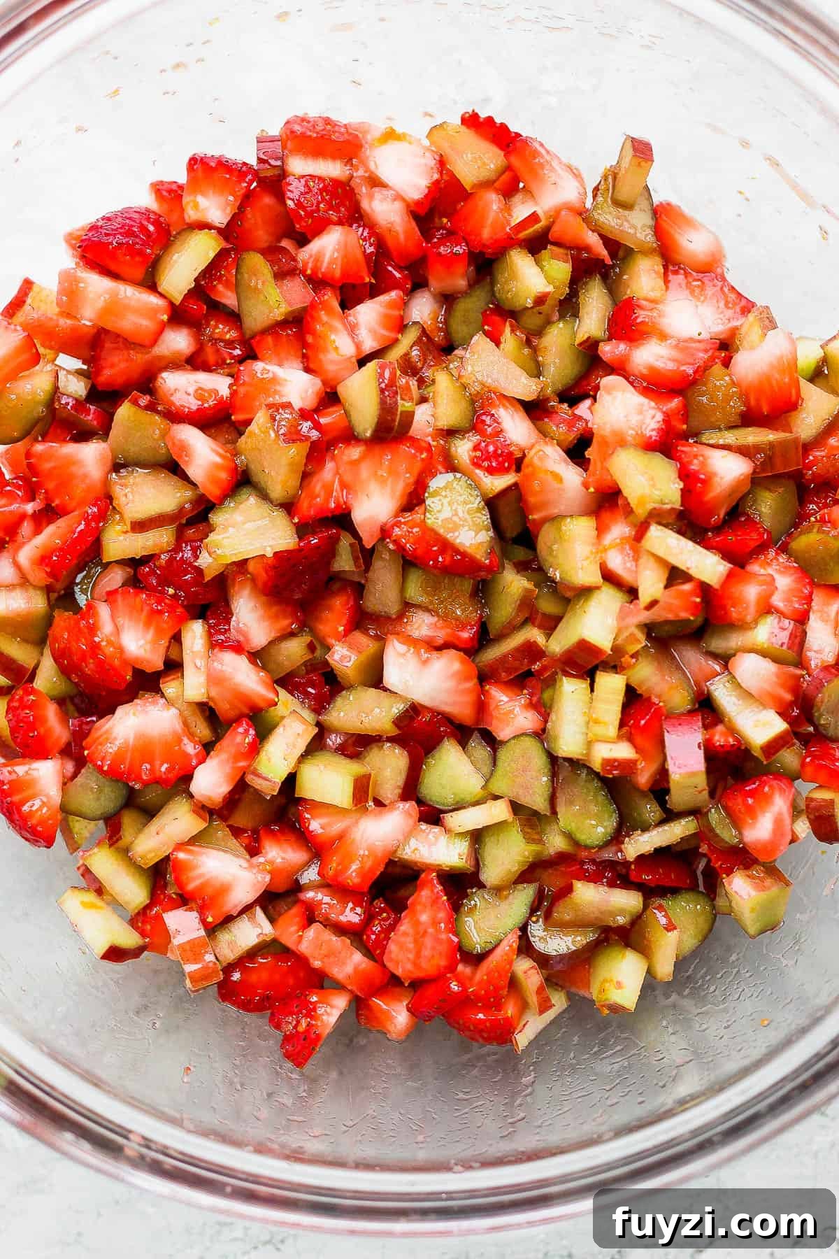 The fully mixed fruit filling in a glass bowl.