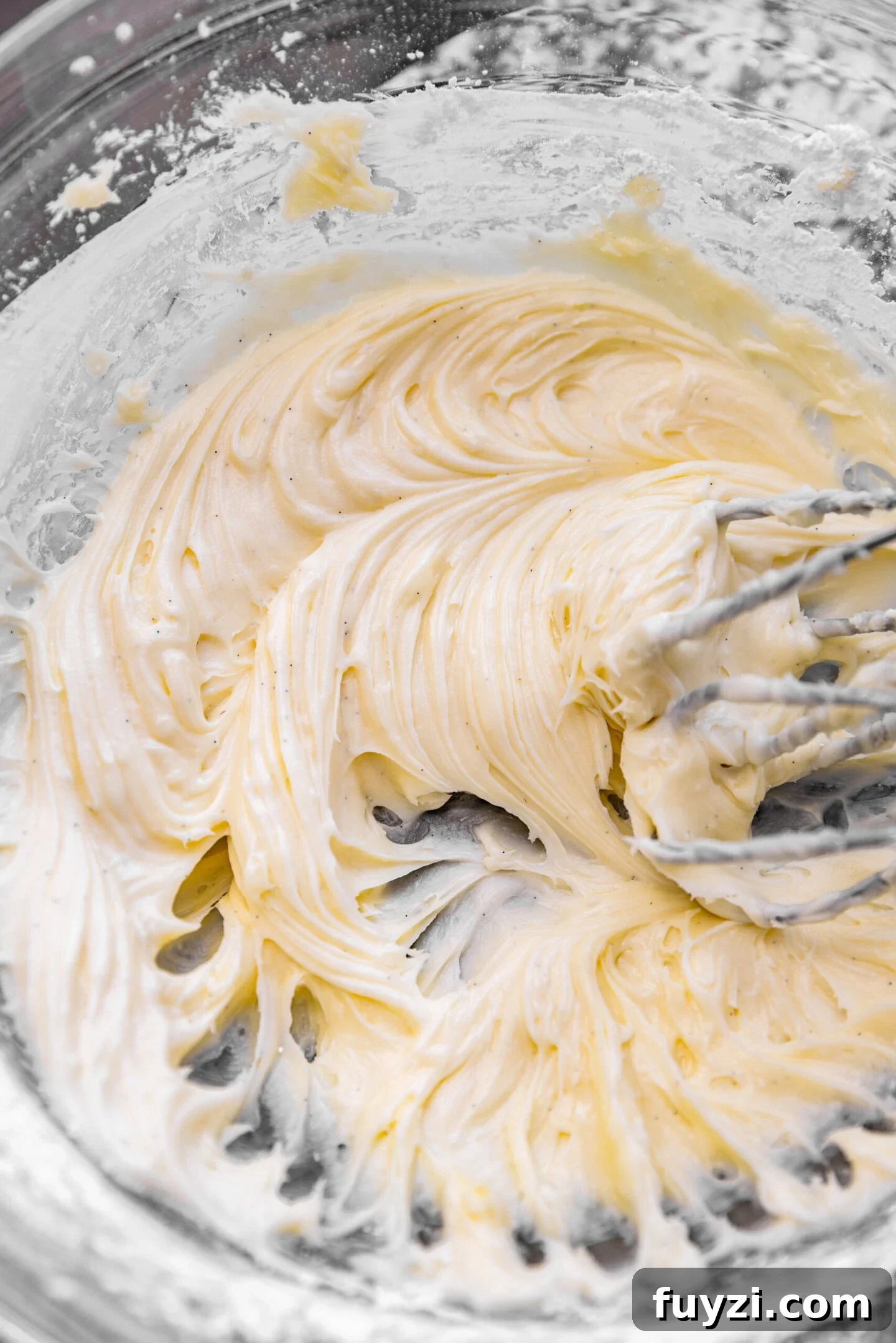 Powdered sugar and vanilla bean paste incorporated into butter and cream cheese mixture.