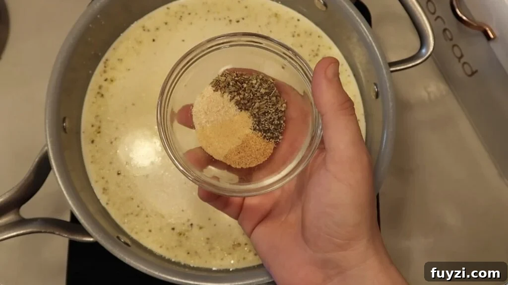 Silky Garlic Cream Sauce Recipe for Pasta and Chicken 10 Adding seasonings to pan