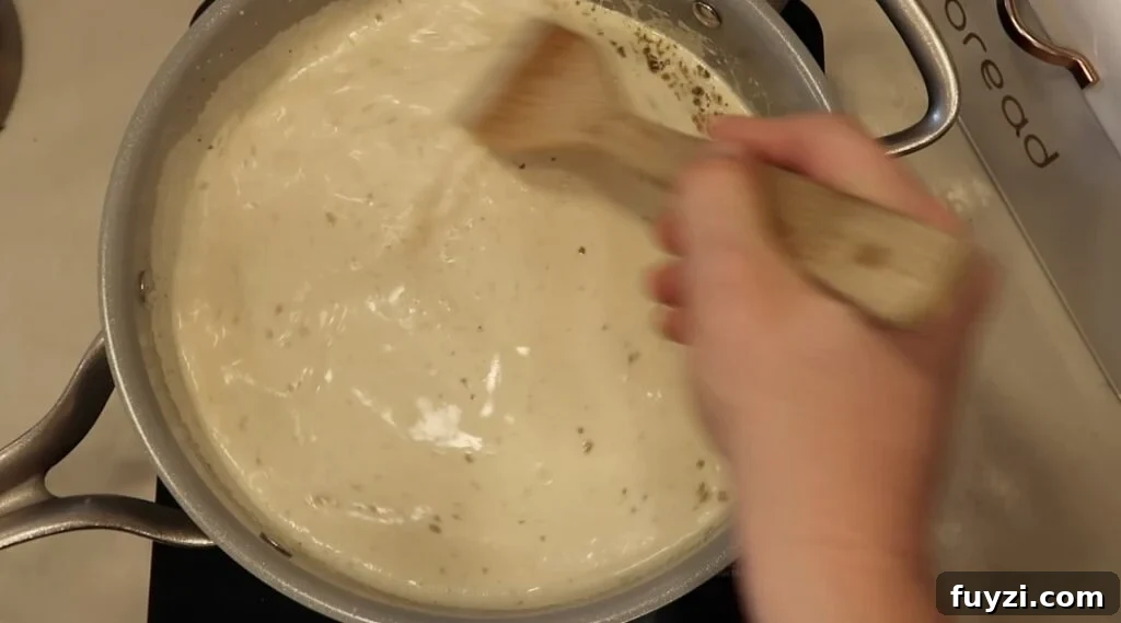 Silky Garlic Cream Sauce Recipe for Pasta and Chicken 12 Stirring pan