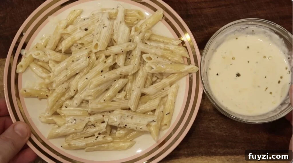 Silky Garlic Cream Sauce Recipe for Pasta and Chicken 18 Plate of pasta and bowl of sauce next to it