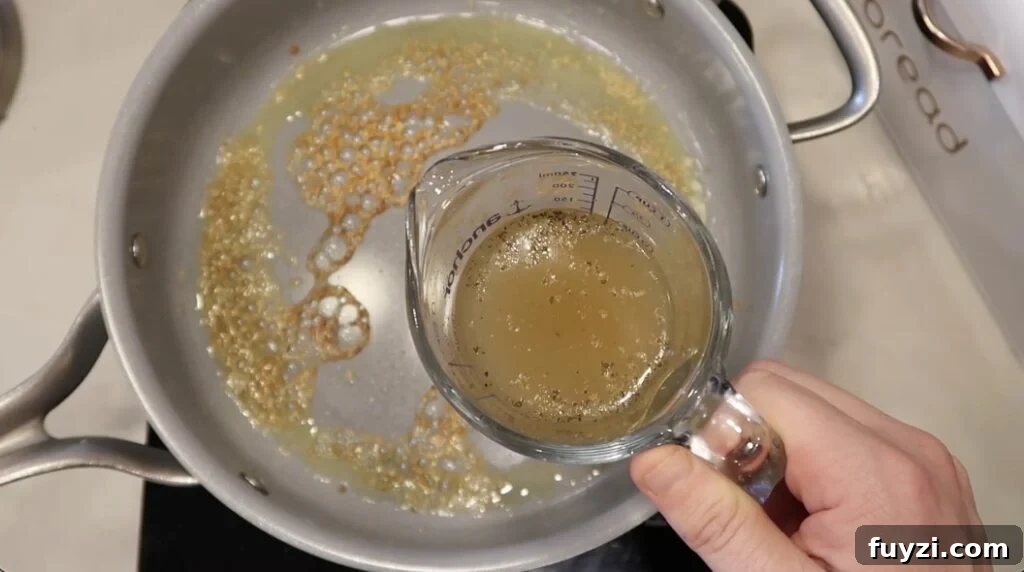 Silky Garlic Cream Sauce Recipe for Pasta and Chicken 7 Broth added to pan