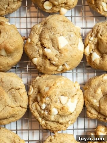White chocolate macadamia nut cookies on a cooling rack.