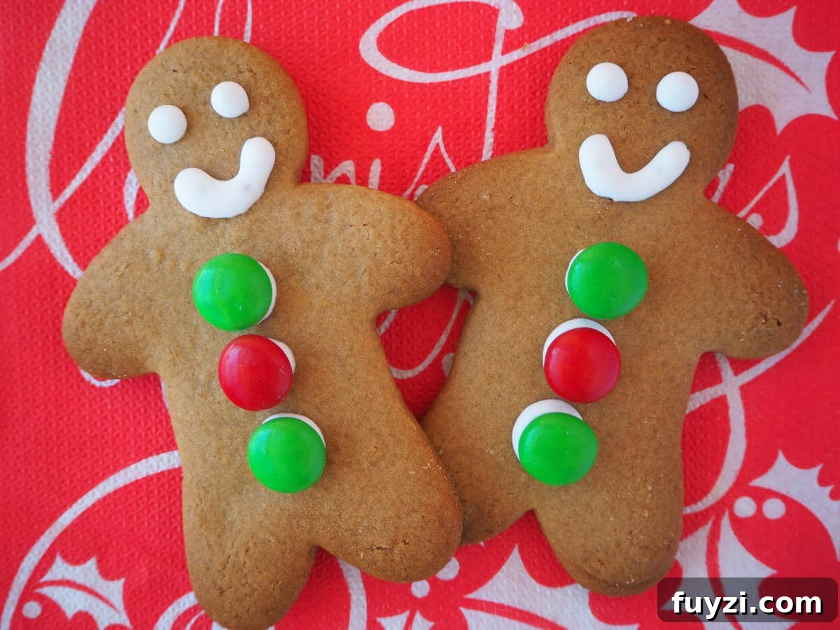 pair of decorated gingerbread med on a red Christmas serviette.