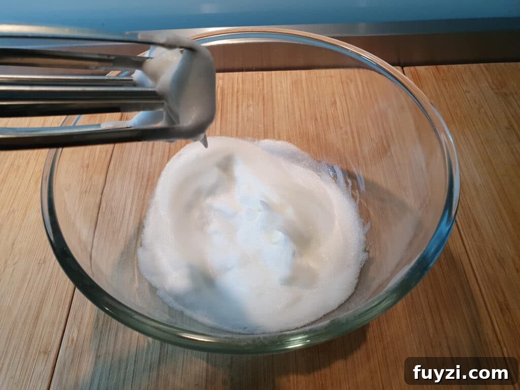 whipping egg white to soft white peaks.