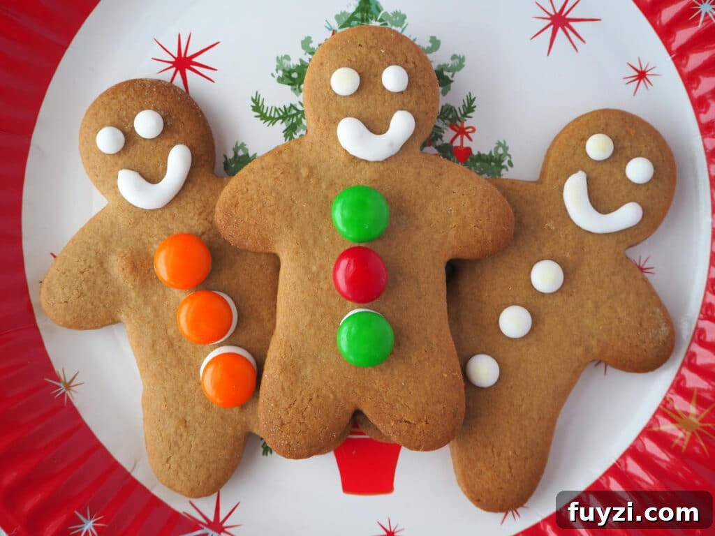 trio of decorated gingerbread med on a Christmas plate.