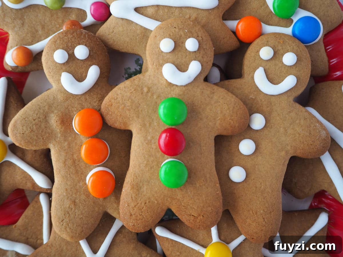 close up of three gingerbread men surrounded by other decorated gingerbread.