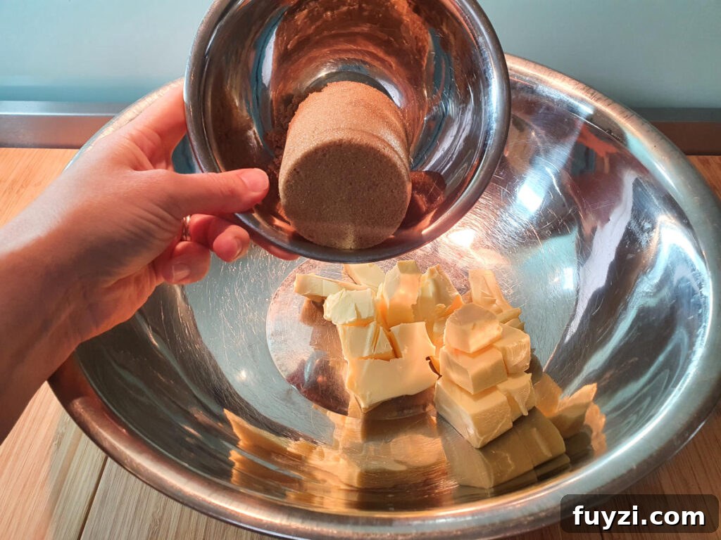 adding brown sugar to room temperature butter in a large mixing bowl.