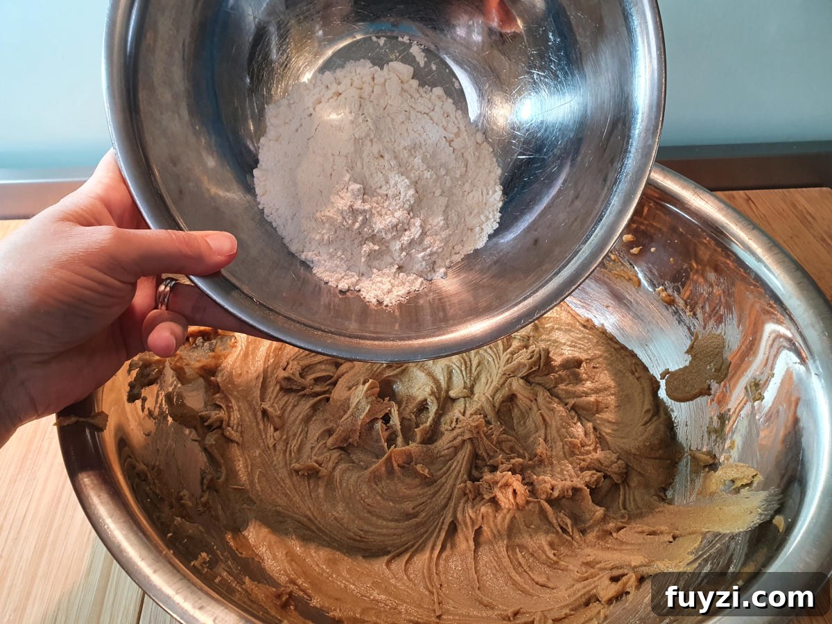 adding flour one cup at a time.